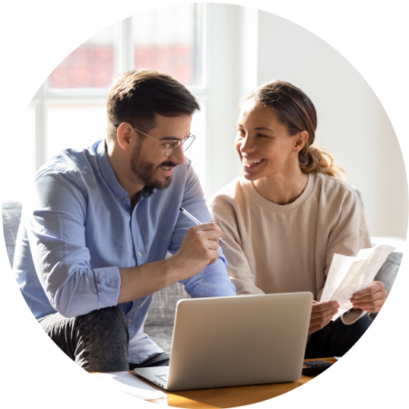 couple conversing and smiling with reviewing their online sales