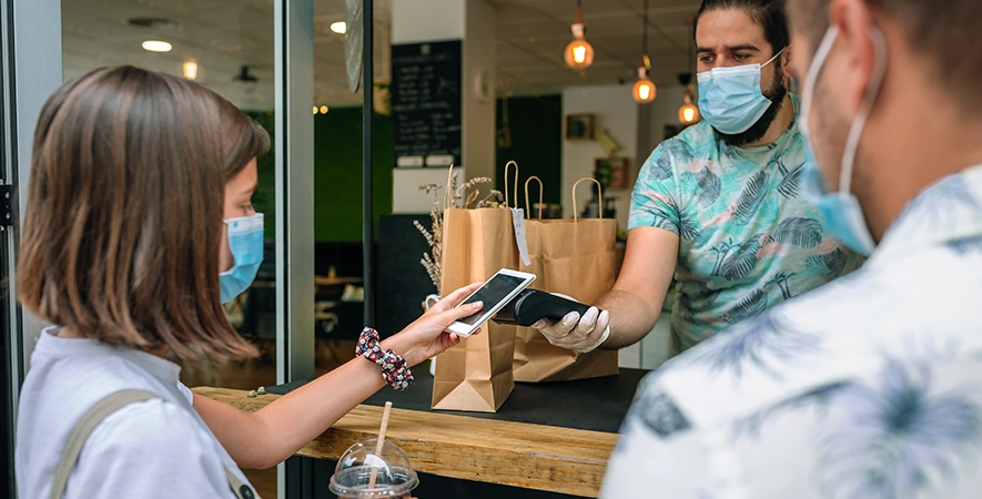 Restaurant owner oversees takeout with a mobile POS terminal after switching from First Data to Sekure.