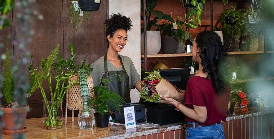 Shop owner making a sale, confident she has the best payment processing solution with the Edge.