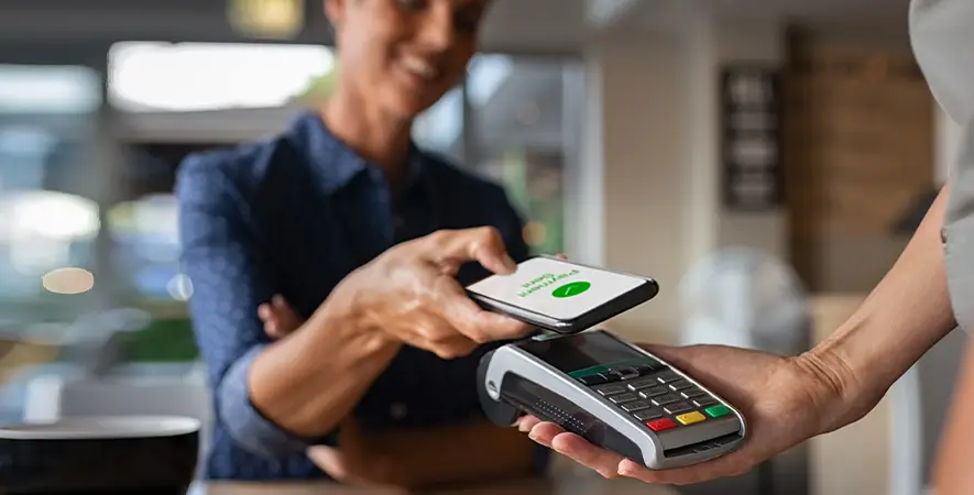 Customer completing a transaction with their NFC-enabled smartphone