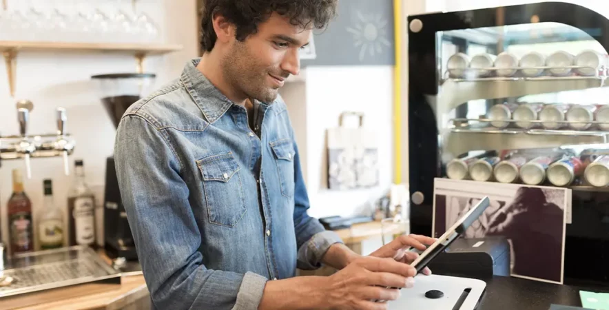 A merchant prepares the bill on a tablet with a cloud-based POS