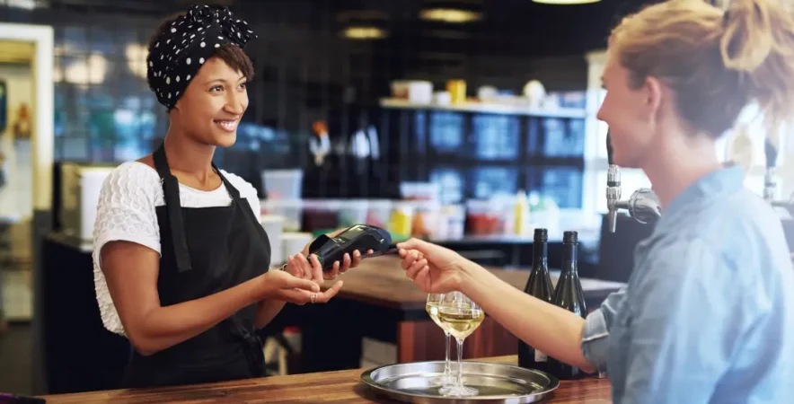 Restaurant owner accepting credit card payment.