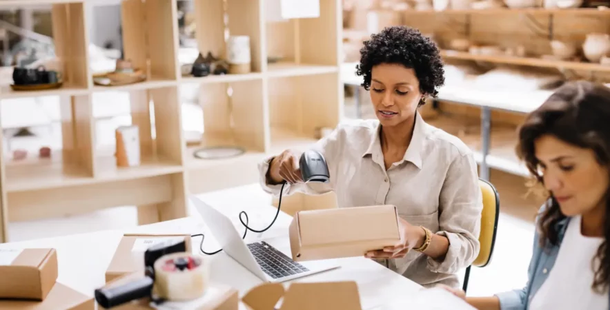 Small business owner scanning product with POS system for their eCommerce.