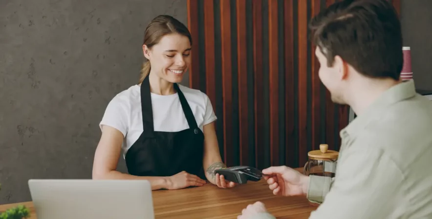 Merchant receiving payment on POS system.