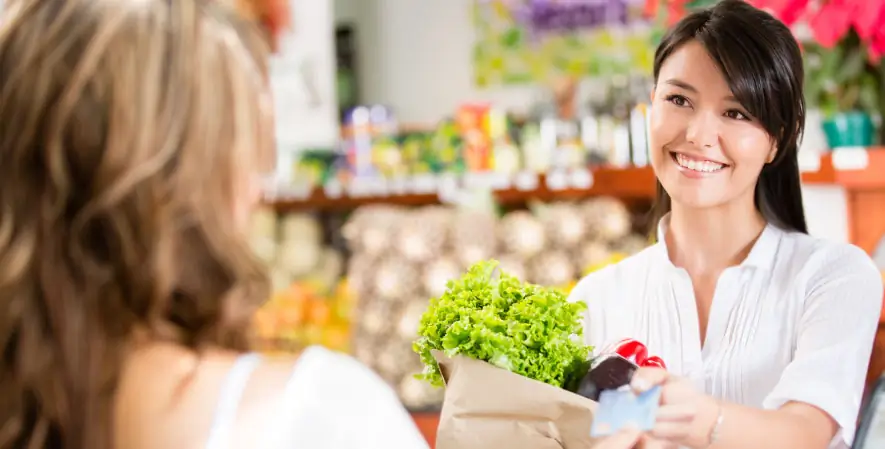 Happy Store owner accepting card payment