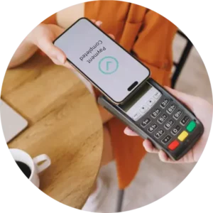 person paying for their coffee order by tapping their phone on the handheld card terminal