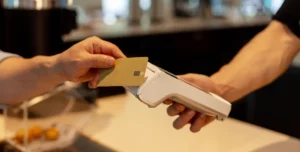 Customer completing a credit card payment as the business incurs credit card merchant fees